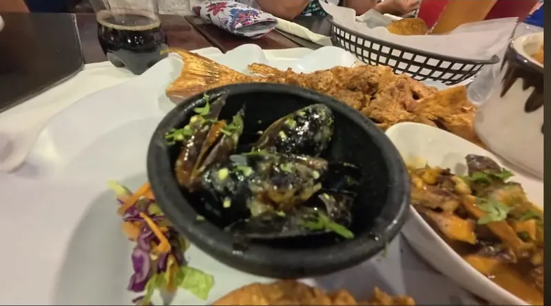 Mussels, a whole fried fish and seafood dishes on the table in Park n Sip’s Caramba visit