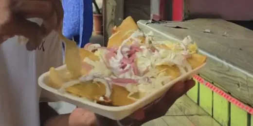 Fried snack with slaw, shown in Blasiantravelerss’s vlog