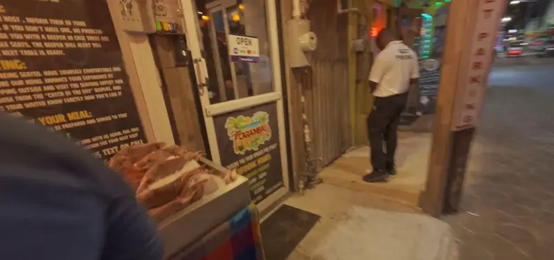 Caramba sign before Ife’s seafood meal · video still by Fly With Ife