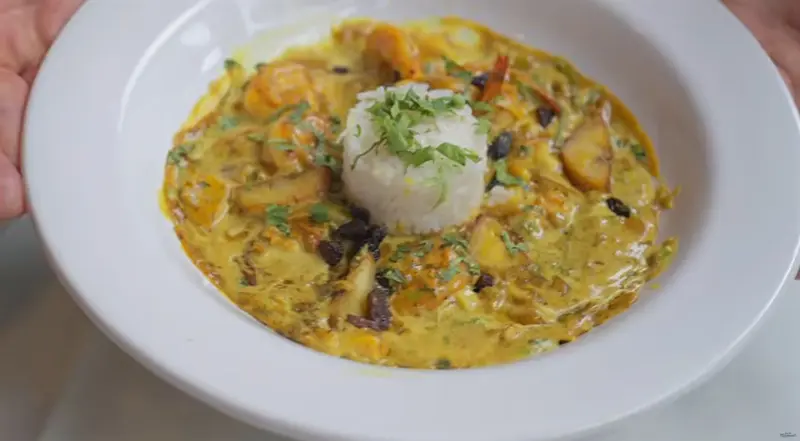 Coconut shrimp curry and rice at Elvi’s Kitchen, captured from Will Mitchell’s vlog